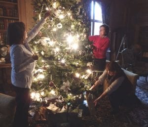 Karen Mills-Lynch (left), Phyllis Kelly and Mary DiFronzo trim the tree in the Vanderbilt Mansion library Vanderbilt Museum photo Karen Mills-Lynch (left), Phyllis Kelly and Mary DiFronzo of the Three Village Garden Club trim the tree in the Vanderbilt Mansion library
