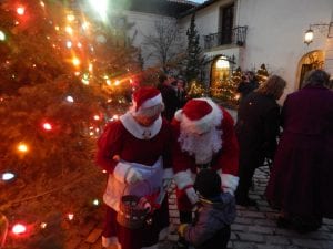 Mr. and Mrs. Claus give treats to children at the Tree Lighting Vanderbilt Museum photo