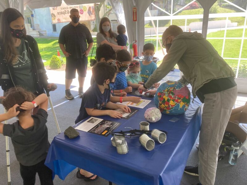 Visitors participating in a STEM activity with an Astronomy Educator.