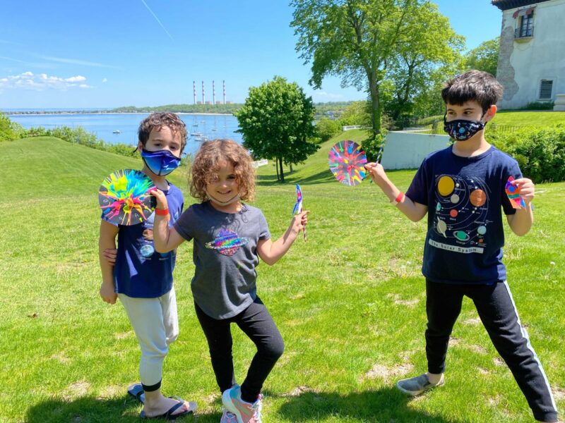 Visitors showing off their Nebula Spin Art crafts.