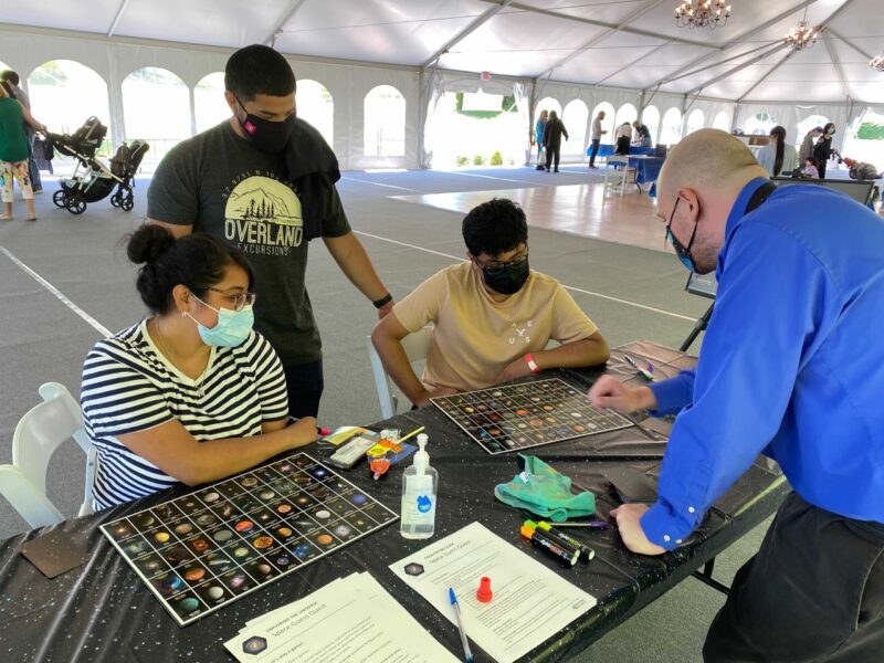 Visitors participating in a STEM activity with an Astronomy Educator.