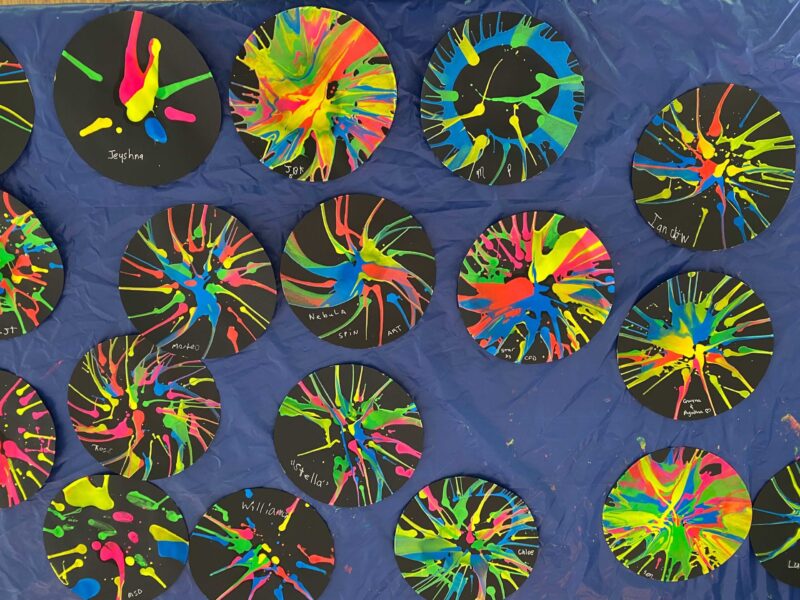 Several Nebula Spin Art crafts laid on a table.