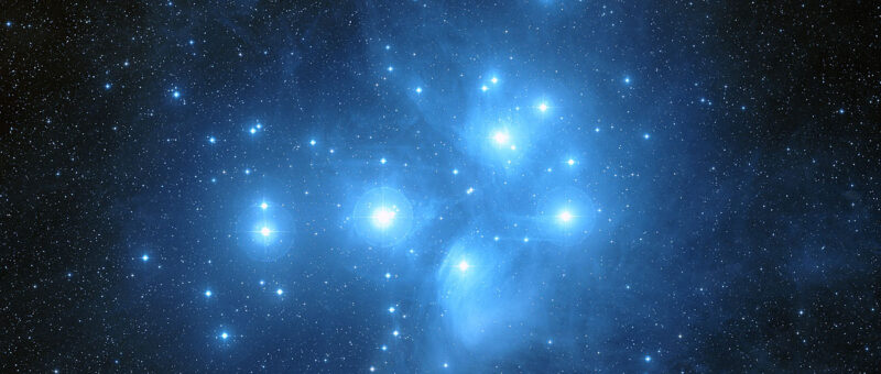 The bright blue Pleadies star cluster is shown on a black background.