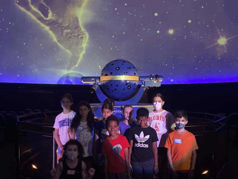 A group of Junior Astronomers in front of our star projector.