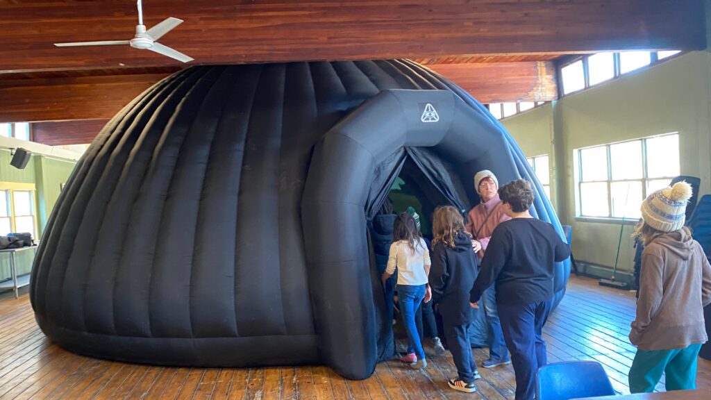 Students entering the inflatable GeoDome portable planetarium